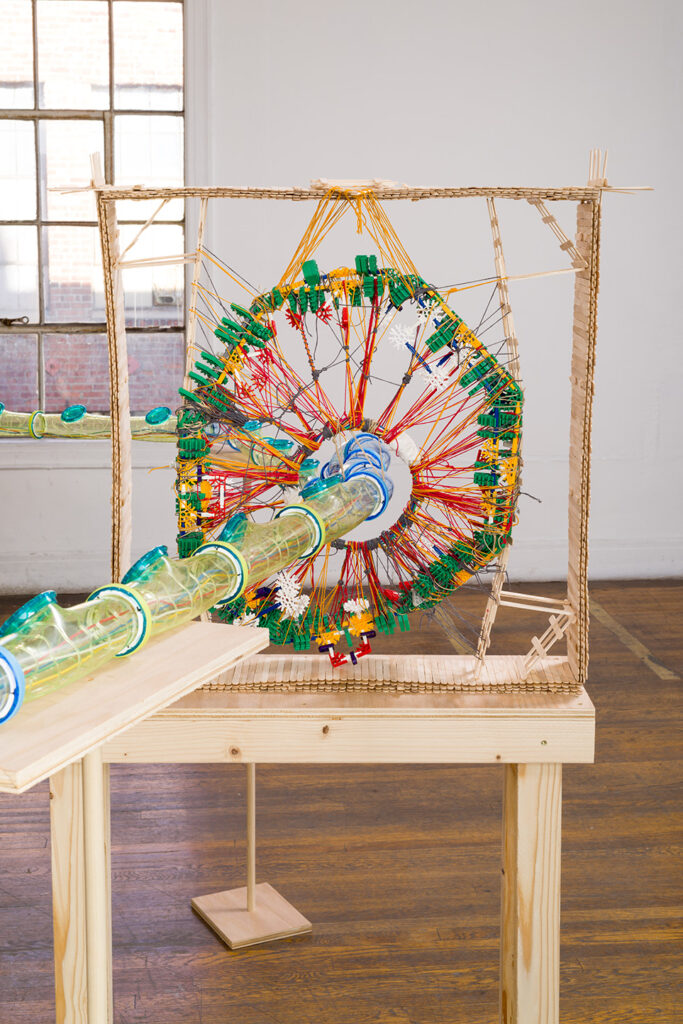 Detail image of the JLS sculpture. It shows hamster tubes going through a web of string and Knex.