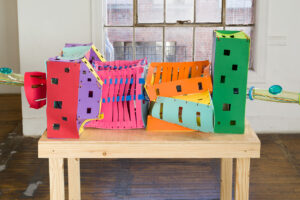 Detail image of the JLS sculpture. It shows a tunnel like structure made out of color pieces of foam.