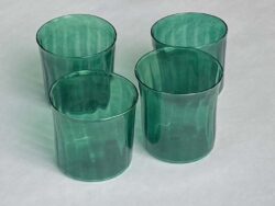 four green blown glass cups with ridges on the surface