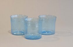three sky blue blown glass cups