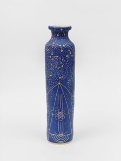 Skeletal II
2022 A tall slender blue wheel-thrown ceramic cylinder that has a smaller bottle neck and flared lip with a white interior. The surface is carved with lines representing pathways of energy movement within the skeletal system.