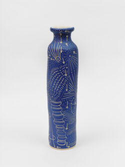 Skeletal II
2022 A tall slender blue wheel-thrown ceramic cylinder that has a smaller bottle neck and flared lip with a white interior. The surface is carved with lines representing pathways of energy movement within the skeletal system.