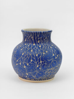 Lymphatic III
2022 A large blue wheel-thrown ceramic vessel that has a wide round shoulder and comes to a smaller opening at the top with a white interior. The surface is carved with images of a bicyclist riding around the center of the pot. Surrounding the cyclist are patterns of lymphatic vessels.
