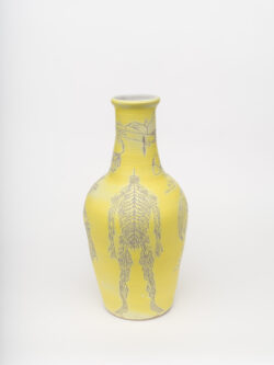 Neural I
2022 A tall, large yellow wheel-thrown ceramic vessel that has a wider round shoulder and comes to a smaller opening at the top, much like a bottle, with a white interior. The surface is carved with diagrams of the nervous system.