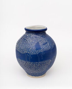 Muscular III
2022 A large blue wheel-thrown ceramic vessel that has a wide round shoulder and comes to a smaller opening at the top with a white interior. The surface is carved with images of a woman doing a forward bend surrounded by patterns representing muscles.