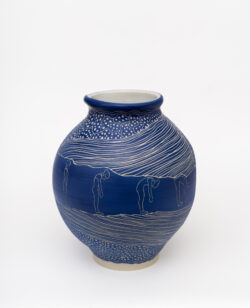 Muscular III
2022 A large blue wheel-thrown ceramic vessel that has a wide round shoulder and comes to a smaller opening at the top with a white interior. The surface is carved with images of a woman doing a forward bend surrounded by patterns representing muscles.