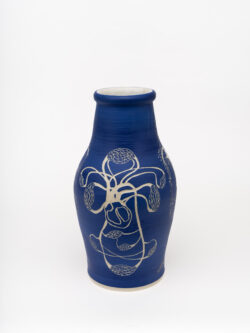 Circulatory I
2022 A large blue wheel-thrown ceramic vessel that has a wide shoulder and comes to a smaller opening at the top with a white interior. The surface is carved with several diagrams representing the circulatory system of the human body.