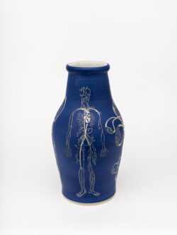 Circulatory I
2022 A large blue wheel-thrown ceramic vessel that has a wide shoulder and comes to a smaller opening at the top with a white interior. The surface is carved with several diagrams representing the circulatory system of the human body.