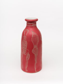 Muscular I 2022 A tall slender red wheel-thrown ceramic cylinder that has a smaller bottle neck and flared lip with a white interior. The surface is carved with different lines of the muscular system of the human body.