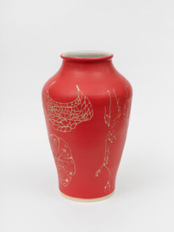 Lymphatic I
2022 A large red wheel-thrown ceramic vessel that has a wide shoulder and comes to a smaller opening at the top with a white interior. The surface is carved with several diagrams representing the lymphatic system of the human body.
