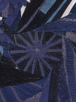 Water 2022 This is a detail of the Water quilt. It shows the blue and black fabric with white squiggly stitching over top.