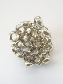 Untitled (Spirit 1) 2023 A cluster of mirrored rings protruding off of the wall.