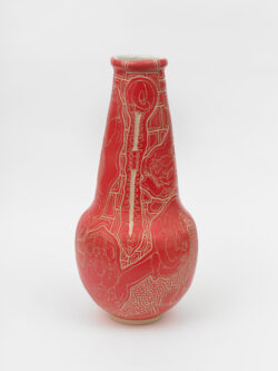 Skeletal III
2022 A red wheel thrown ceramic vessel that is wider at the bottom, has a long conical neck and a white interior. The surface has intricate carvings of hands holding a skull in various positions representing different Cranial Sacral holds.
