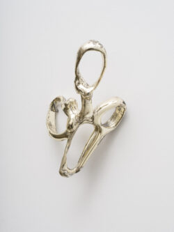 Untitled (Spirit 5) 2023 A cluster of mirrored rings protruding off of the wall. Resembling something found in the ocean or on a molecular scale.