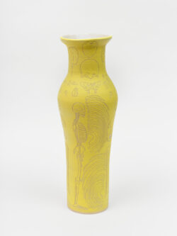 Skeletal I
2022 A tall, yellow wheel-thrown ceramic vessel that has a wider round shoulder and comes to a smaller opening at the top, much like a bottle, with a white interior. The surface is carved with diagrams of the skeletal system.