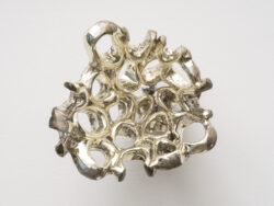 Untitled (Spirit 2)
2023 A cluster of mirrored rings protruding off of the wall. Resembling something found in the ocean or on a molecular scale.
