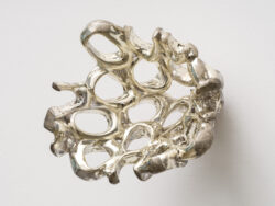 Untitled (Spirit 2)
2023 A cluster of mirrored rings protruding off of the wall. Resembling something found in the ocean or on a molecular scale.