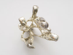 Untitled (Spirit 6)
2023 A cluster of mirrored stretched rings protruding off of the wall. Resembling something found in the ocean or on a molecular scale.
