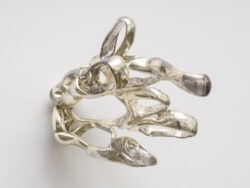 Untitled (Spirit 6)
2023 A cluster of mirrored rings protruding off of the wall. Resembling something found in the ocean or on a molecular scale.