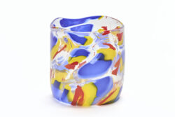 Large blown glass cylinder with blue, yellow and red wavy blotches of color throughout.