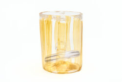 Large blown glass cylinder with orange stripes throughout. Inside the vessel is a solid glass weight with a ring on the top as a handle.