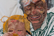 A detailed image of the textile Maw and Marilyn Eat Cookies. It shows the intricate embroidery of their faces.