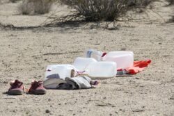 Empty Water Body
2015 Photograph of empty water bottles all lined up as though they were a body laying on the desert ground.