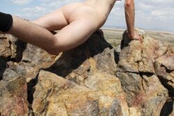 F*cking a Rock
2015 Photograph of a naked white person from behind doing a push up over a pile of rocks in the desert.